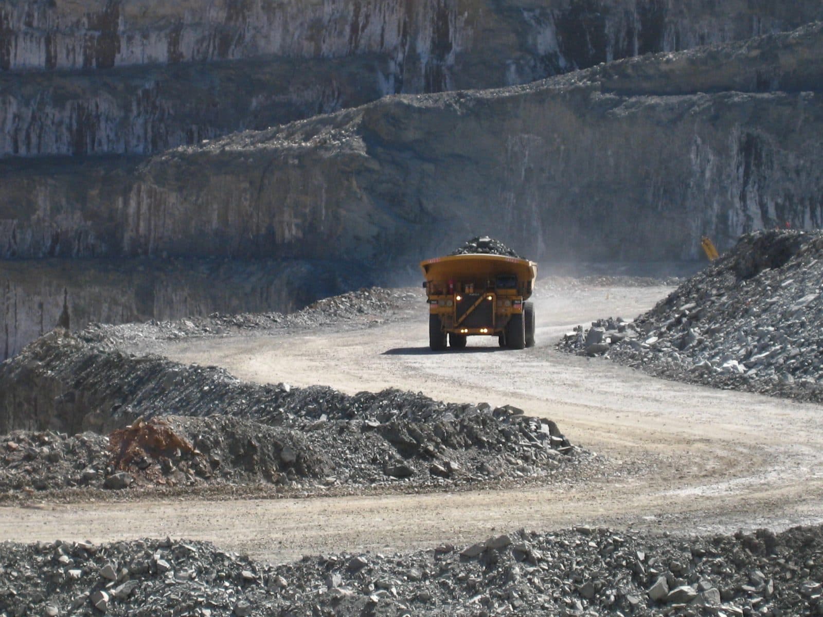 Mining truck on a haul road at the bottom of a pit
